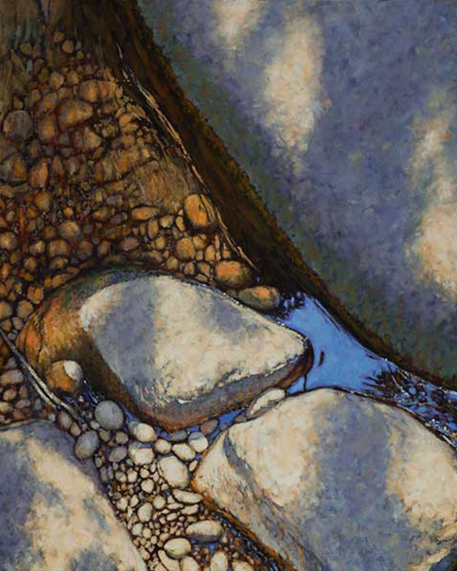 Close up of water gently flowing over rocks and pebbles.